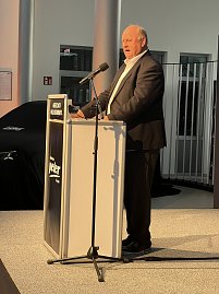 Helmut Peter begr&uuml;&szlig;t die G&auml;ste auf der B&uuml;hne am Rednerpult.